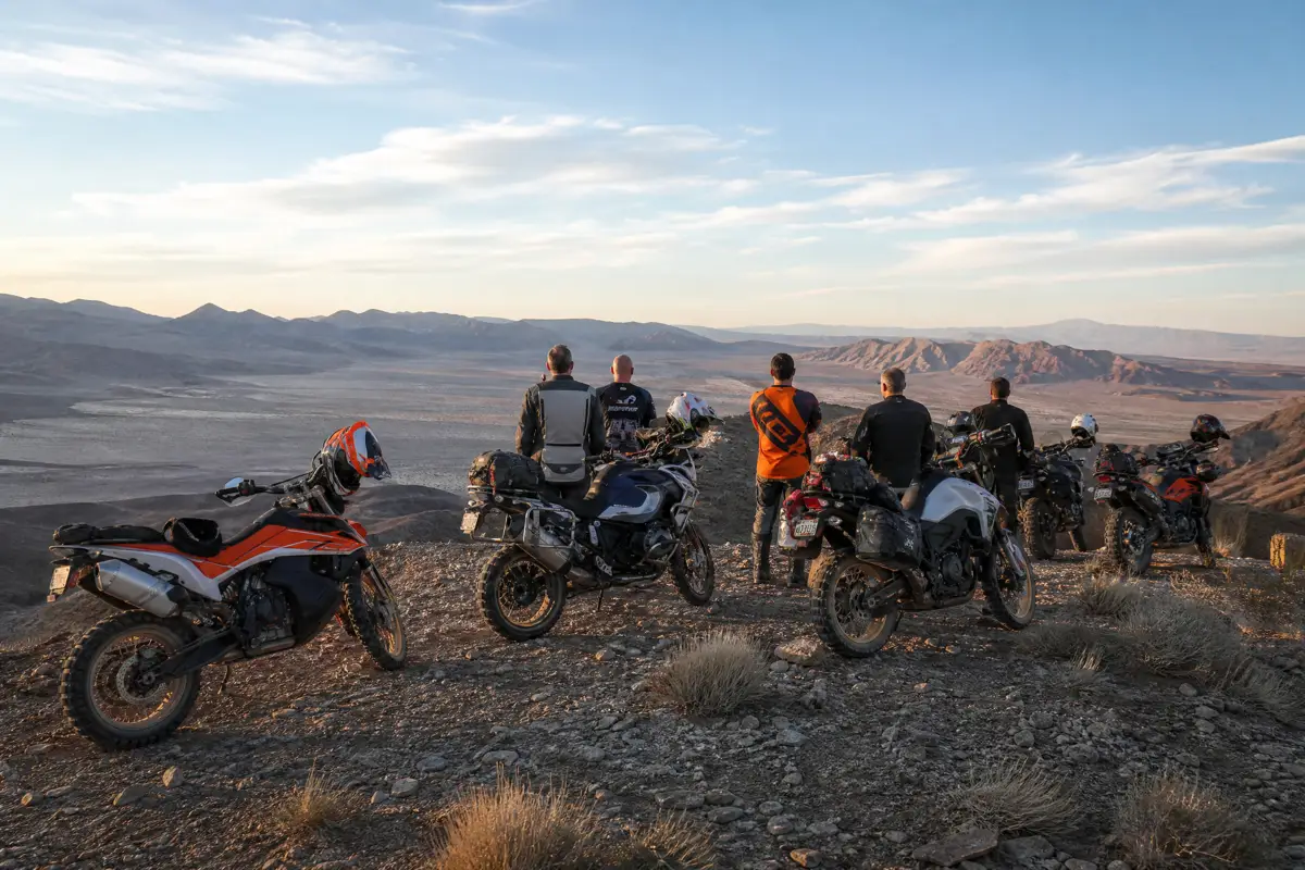 A group of riders and their bikes at a scenic overlook