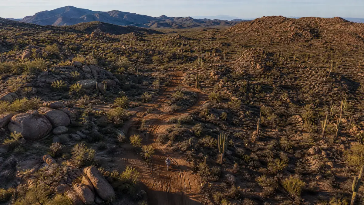 An aerial view of a motorcycle riding a remote trail
